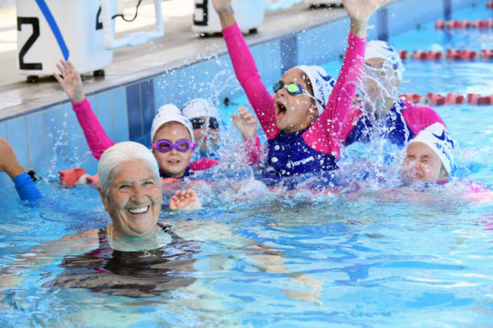 Dawn Fraser having fun with the next wave in generations of 'em Down Under, potential all the more likely to be fulfilled if parents and coaches can work in partnership - photo by Delly Carr, courtesy of Swimming Australia