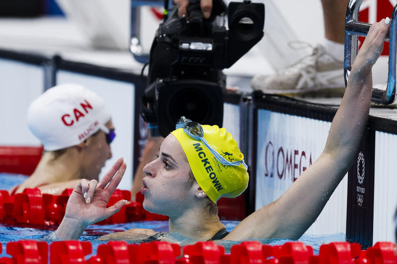 Kaylee McKeown, of Australia, celebrates by blowing the smoke off the gun after hitting her second target for the Olympic backstroke double in Tokyo - by Patrick B. Kraemer
