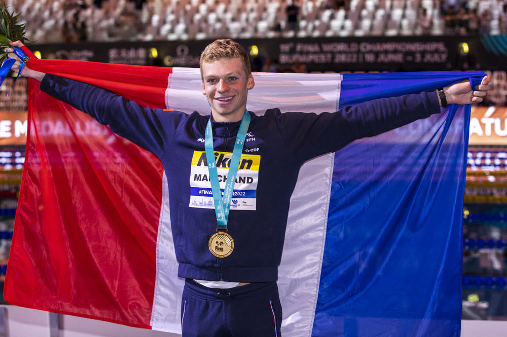 Leon Marchand ARCHAND of France poses with his Gold medal and a French flag after winning in the Men's 200m Individual Medley (IM) Final during the swimming events of the 19th Fina World Championships held at the Duna Arena in Budapest, Hungary, Wednesday, June 22, 2022.