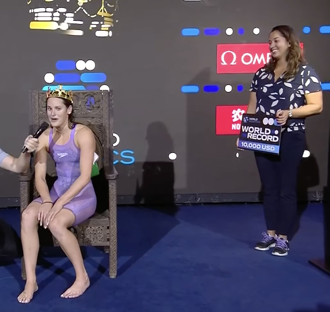 Kaylee McKeown, wearing the crown as backstroke queen, the laurel placed on her head by Ranomi Kromowidjojo, 2012 double Olympic freestyle sprint champion for The Netherlands