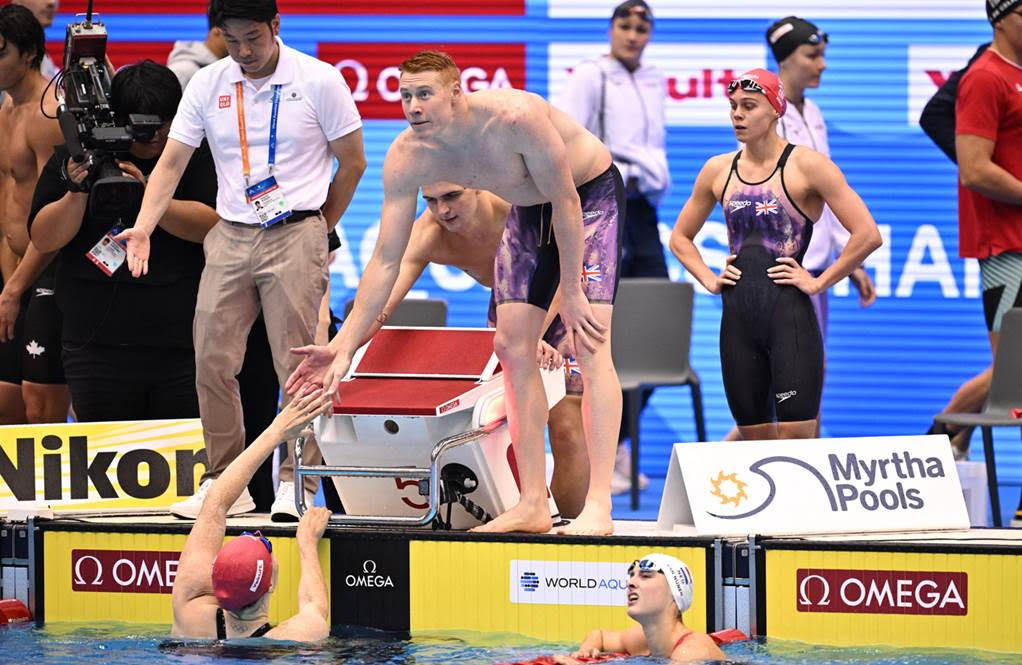 Tom Dean congratulates relay mate Freya Anderson