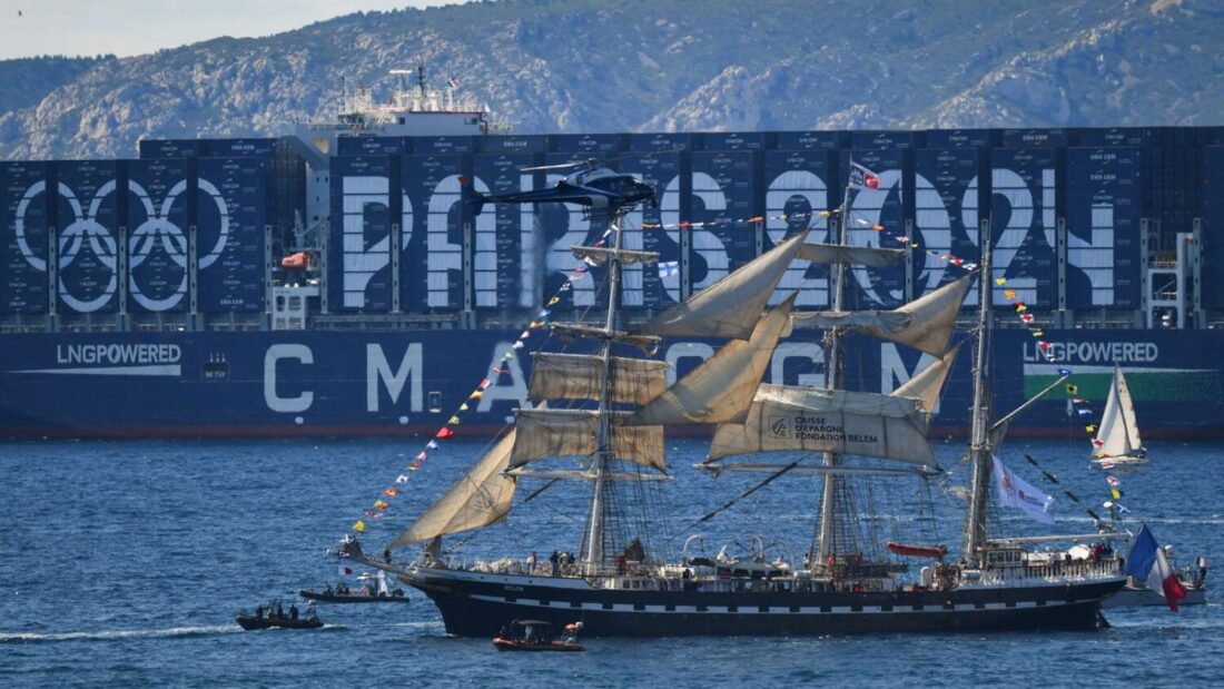 The Belem approaches the Old Port of Marseille with the Olympic Torch before Florent Manaudou delivers the flame to shore and French President Emmanuel Macron - photo courtesy of Agence France Press (AFP)